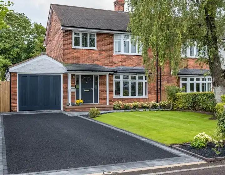Fresh tarmac driveway with paved edging after installation